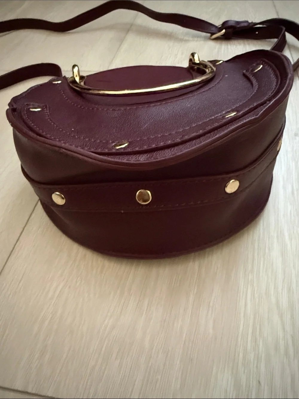 Round Crossbody Bag in Plum with Gold Accents